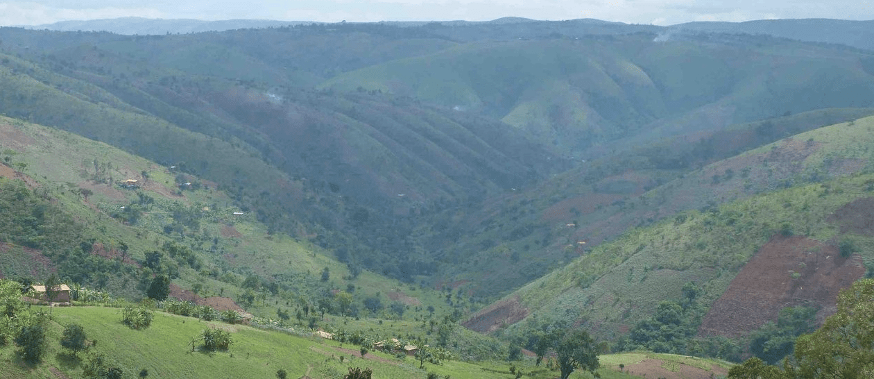 Scenic view of the rolling green hills and traditional villages of rural Burundi